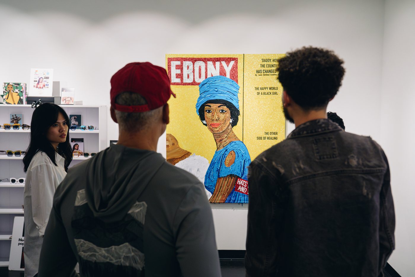 Visitors viewing an EBONY cover painting at Prizm Art Fair